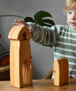 Child playing with the Ostheimer castle sentry post building with bell handmade wooden toy.