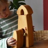 Child playing with the Ostheimer castle sentry post building with bell.