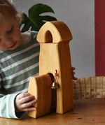 Child playing with the Ostheimer castle sentry post building with bell.