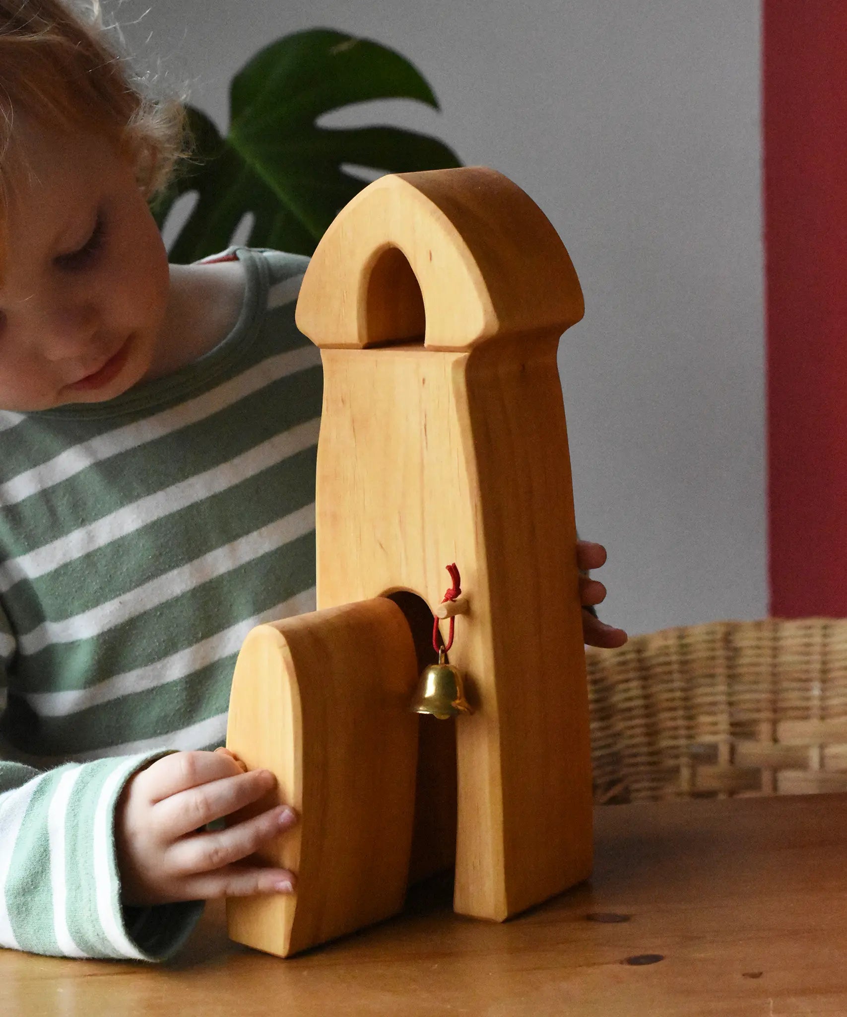 Child playing with the Ostheimer castle sentry post building with bell.