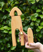 Ostheimer castle sentry post building with bell handmade wooden toy in a child's hand with the door in another hand.