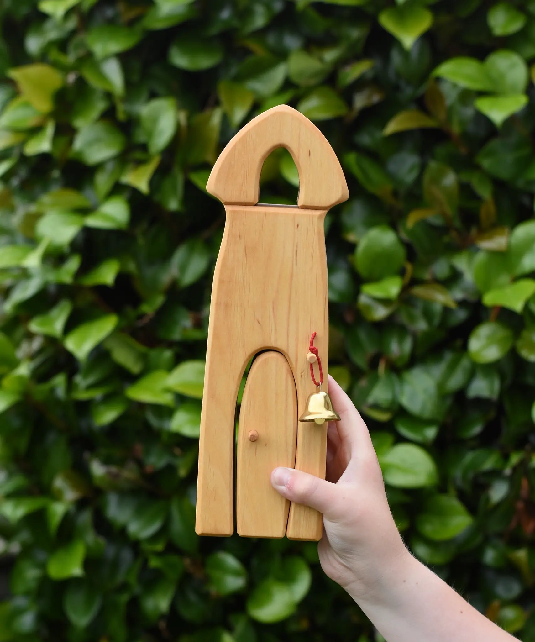 Ostheimer castle sentry post building with bell handmade wooden toy in a child's hand.