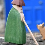 Ostheimer shepherd with staff placed on a stone wall outdoors.