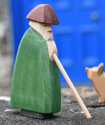 Ostheimer shepherd with staff placed on a stone wall outdoors.