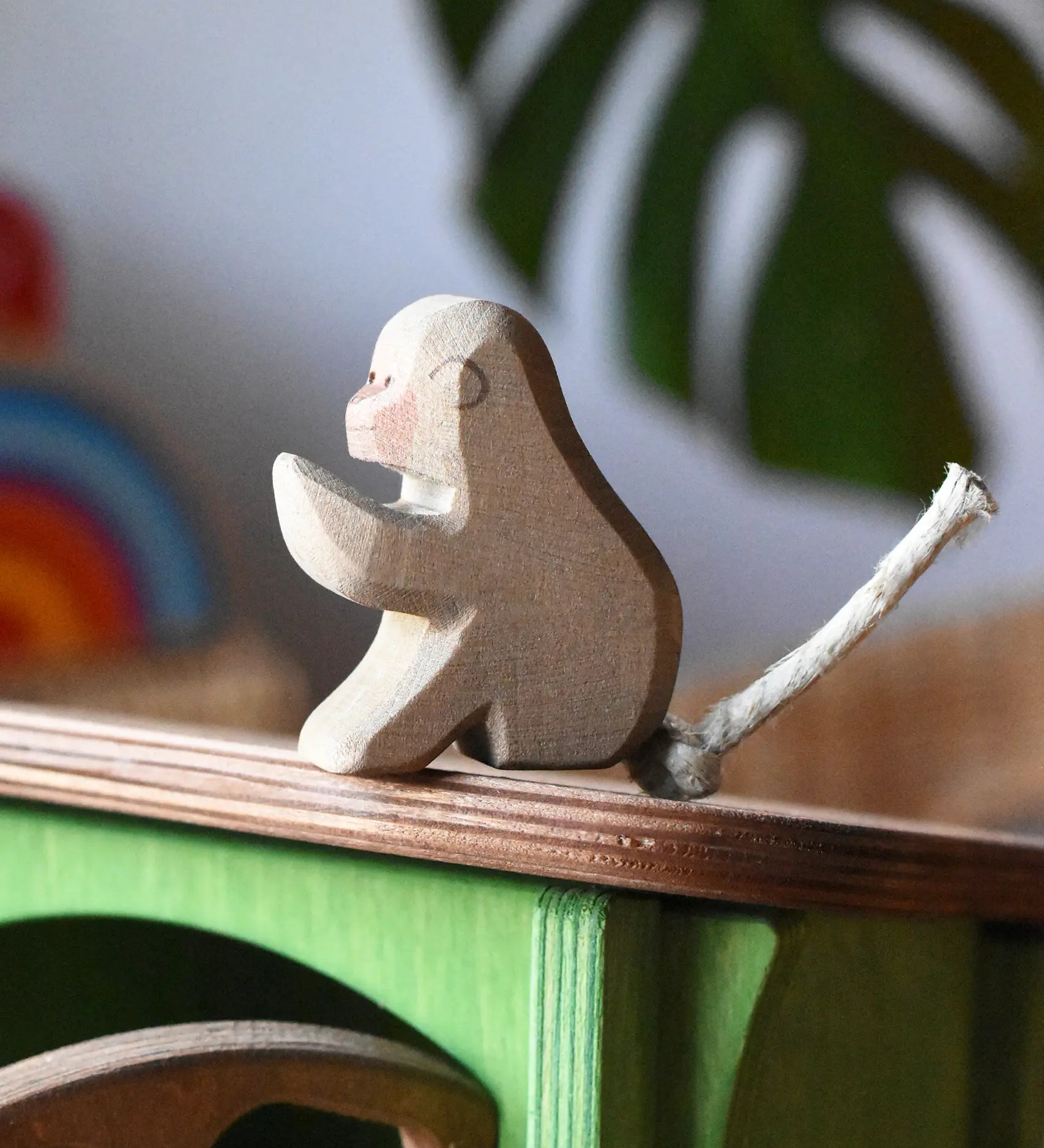 Ostheimer sitting baboon placed on the roof of the Ostheimer hutch for toy animals. 
