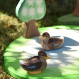 Ostheimer swimming and sitting duck wooden toy figures placed on a pond piece in the Babipur garden. 