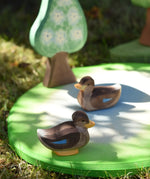 Ostheimer swimming and sitting duck wooden toy figures placed on a pond piece in the Babipur garden. 