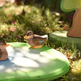 Ostheimer sitting duck wooden toy figure placed on a pond piece in the Babipur garden. 