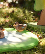 Ostheimer sitting duck wooden toy figure placed on a pond piece in the Babipur garden. 