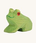 Ostheimer Sitting Frog wooden toy figure on a plain background. 