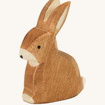 Ostheimer sitting rabbit wooden toy figure on a plain background. 