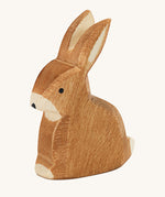Ostheimer sitting rabbit wooden toy figure on a plain background. 