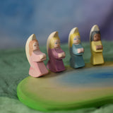 Four Ostheimer little angels placed on a wooden pond scene piece. These wooden figures are part of a wide range of expertly hand crafted wooden toys here at Babipur. 