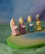 Four Ostheimer little angels placed on a wooden pond scene piece. These wooden figures are part of a wide range of expertly hand crafted wooden toys here at Babipur. 