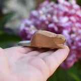A small Ostheimer wooden toy figure shown on an adult's hand to show scale. Check out our full range of expertly crafted wooden toy figures and scenery here at Babipur.