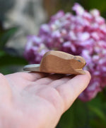 A small Ostheimer wooden toy figure shown on an adult's hand to show scale. Check out our full range of expertly crafted wooden toy figures and scenery here at Babipur.
