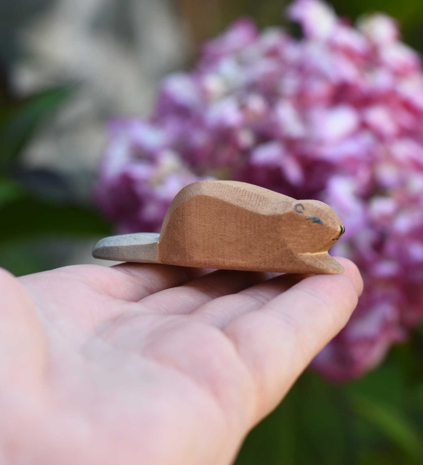A small Ostheimer wooden toy figure shown on an adult's hand to show scale. Check out our full range of expertly crafted wooden toy figures and scenery here at Babipur.