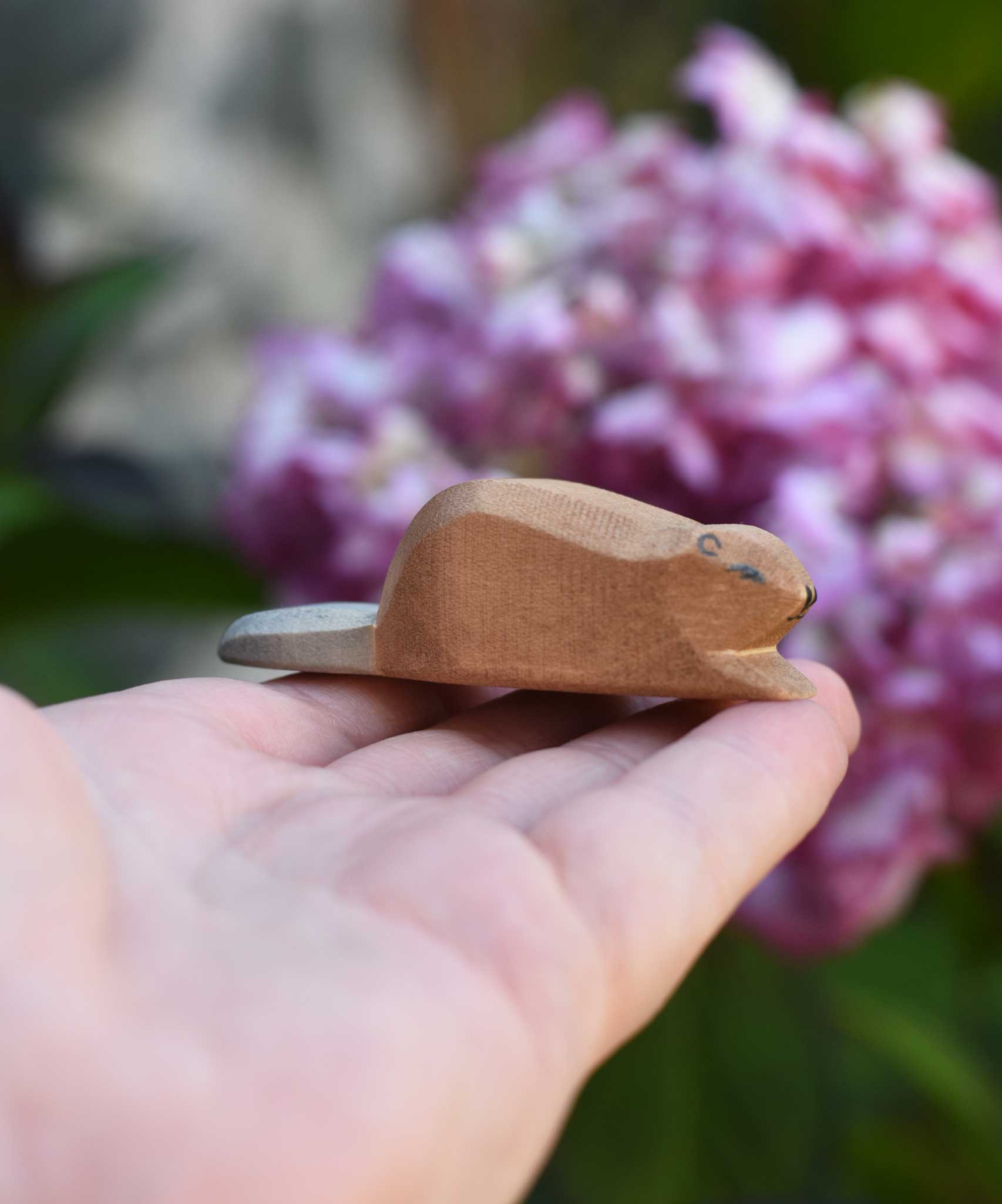 A small Ostheimer wooden toy figure shown on an adult's hand to show scale. Check out our full range of expertly crafted wooden toy figures and scenery here at Babipur.