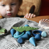 Small Ostheimer crocodile placed on a pile of blue coloured Grapat mandala pieces and rings.