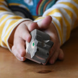 Ostheimer small hippopotamus wooden toy figure in a child's hand. 
