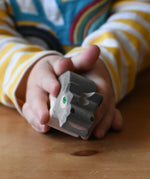 Ostheimer small hippopotamus wooden toy figure in a child's hand. 