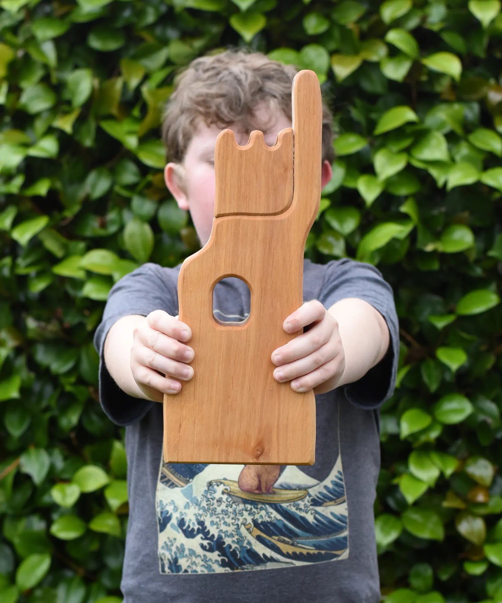 Child holding the Ostheimer small wooden lookout tower wooden toy.