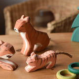 Ostheimer tigers placed on a wooden surface with the small lurking tiger at the front. 