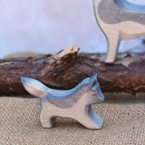 A close up of the small running Osthimer wolf figure placed in a small world play scene. Check out our full range of expertly crafted wooden toy figures and scenery here at Babipur.