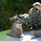 Ostheimer small  sea otter wooden toy figure placed on a pond play scenery piece in a small world play set up.
