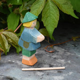 Ostheimer small shepherd boy wooden toy figure with his staff removed from the holder in his hands and placed on the slate in front of him.