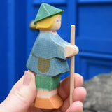 Ostheimer small shepherd boy wooden toy figure in an adult's hand.