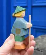 Ostheimer small shepherd boy wooden toy figure in an adult's hand.