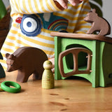 Ostheimer bear and small sitting brown bear wooden toy figures in a small world play scene with the green hutch, small spruce tree, Grapat rings and animal Nins and small Kraul basket.