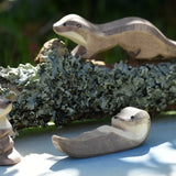 Ostheimer small swimming sea otter wooden toy figure placed on on Ostheimer pond play scenery piece. 