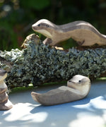 Ostheimer small swimming sea otter wooden toy figure placed on on Ostheimer pond play scenery piece. 
