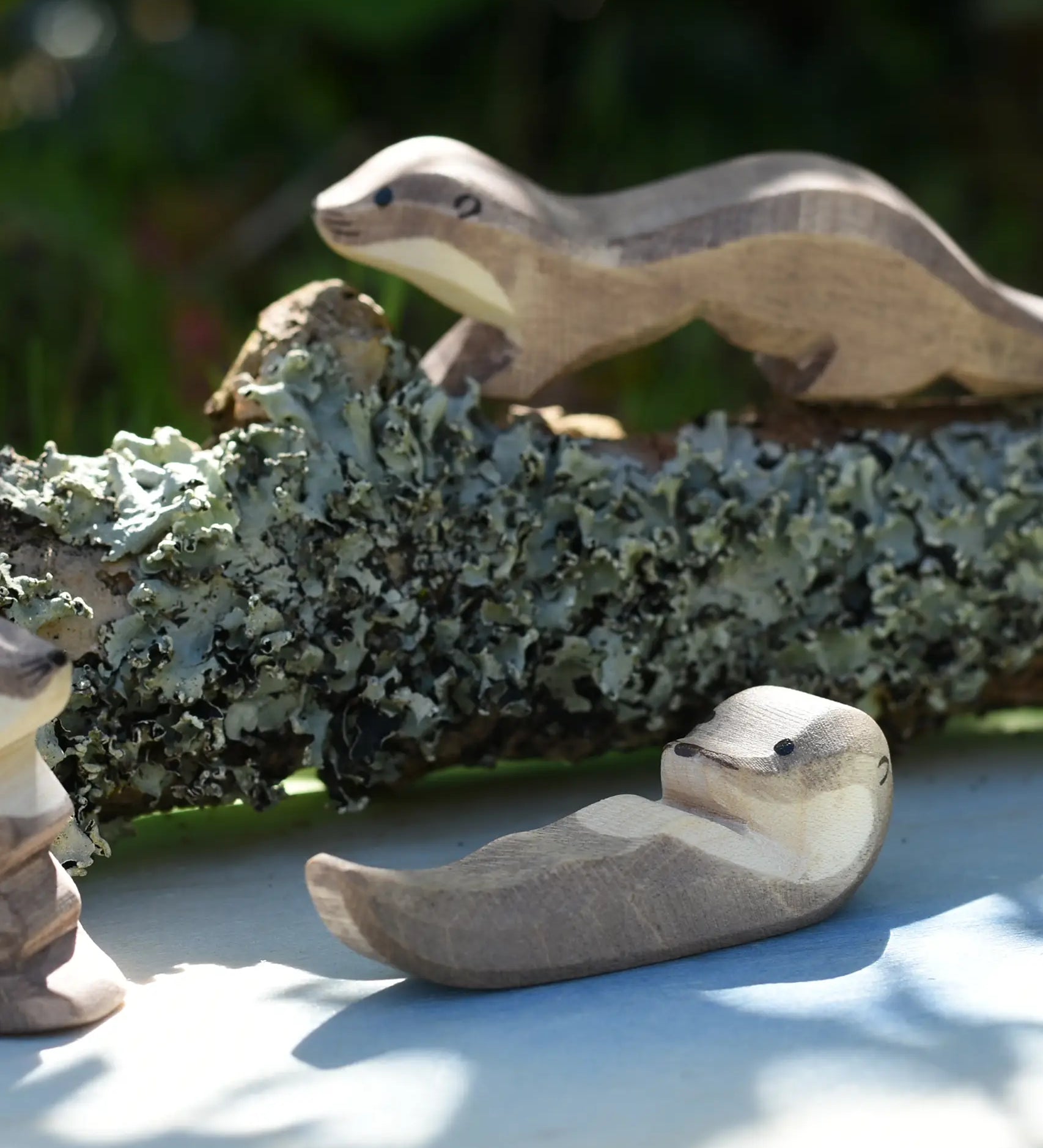 Ostheimer small swimming sea otter wooden toy figure placed on on Ostheimer pond play scenery piece. 