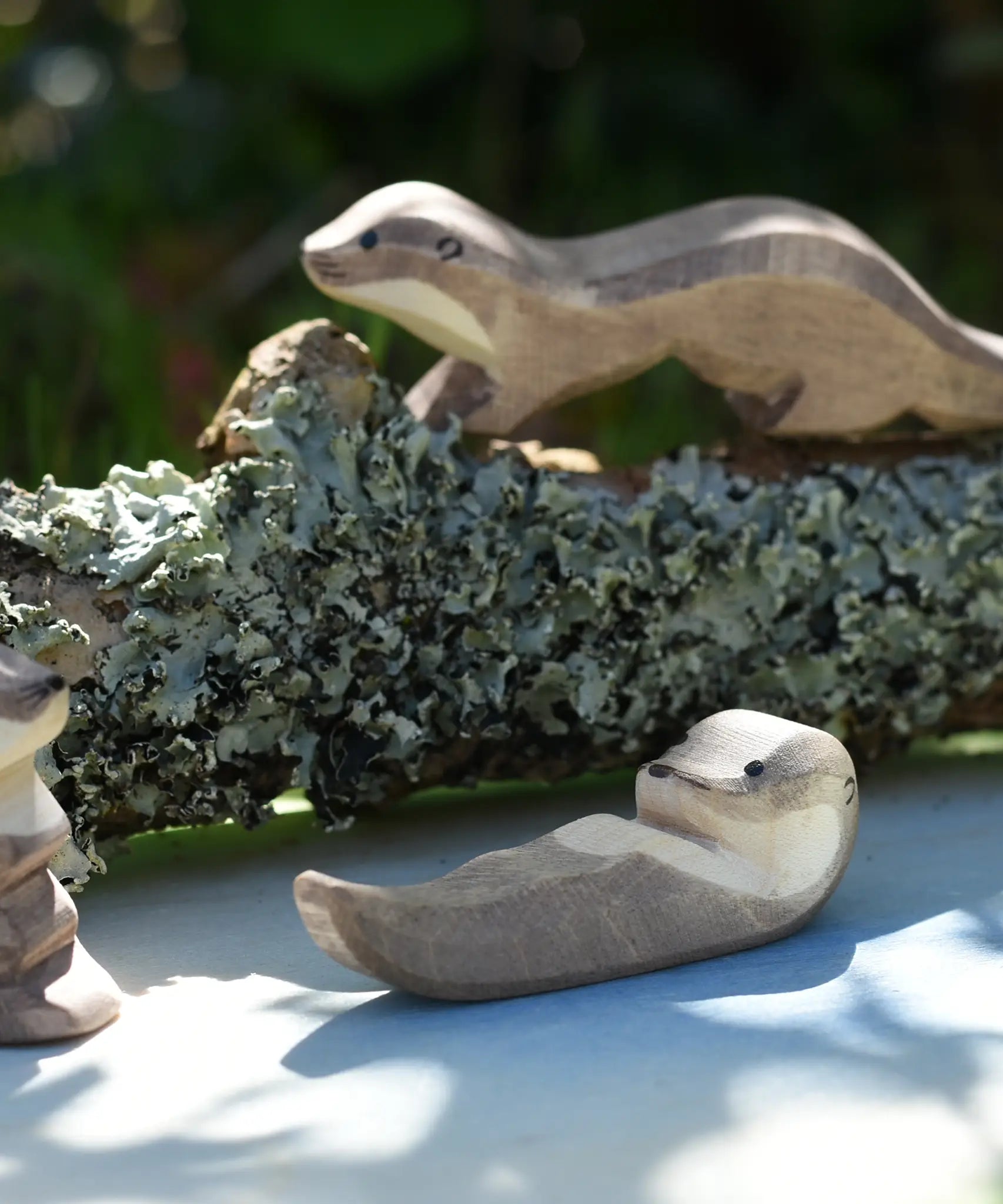 Ostheimer small swimming sea otter wooden toy figure placed on on Ostheimer pond play scenery piece. 
