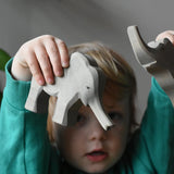 Ostheimer small elephant with trunk out in a child's hand.