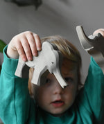 Ostheimer small elephant with trunk out in a child's hand.