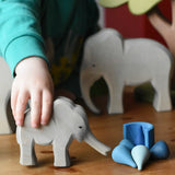 Ostheimer small elephant with trunk out in a child's hand and Grapat water mandala pieces.