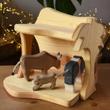 Ostheimer small wooden toy stable with cow figures placed inside. 