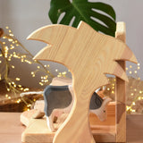 Side of Ostheimer small wooden toy stable showing the palm tree shaped side.