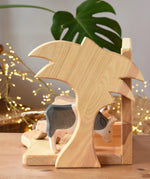 Side of Ostheimer small wooden toy stable showing the palm tree shaped side.