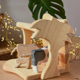 Ostheimer small wooden toy stable with cow figures placed inside. 