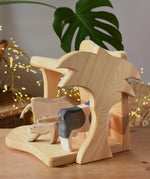 Ostheimer small wooden toy stable with cow figures placed inside. 