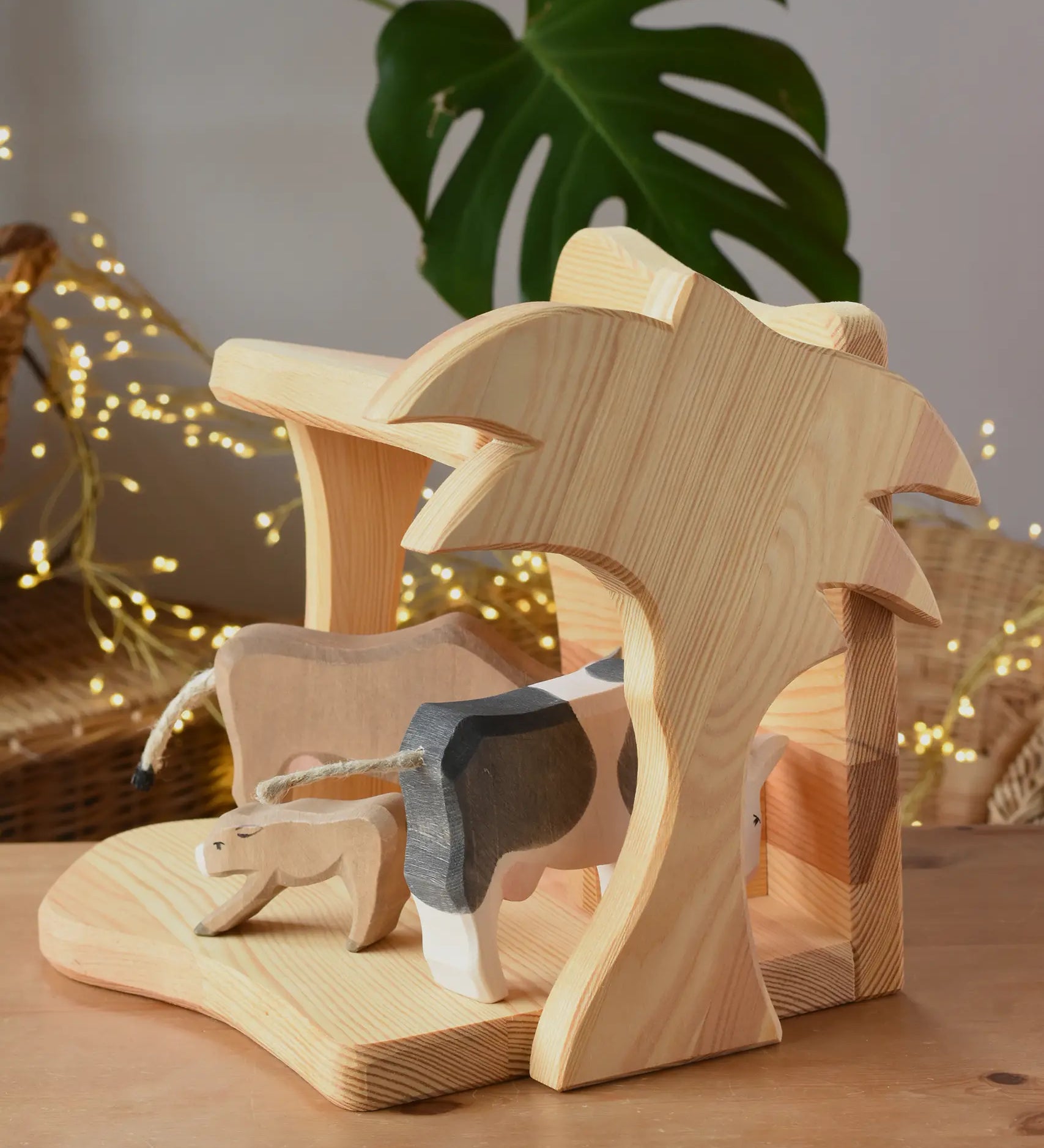 Ostheimer small wooden toy stable with cow figures placed inside. 