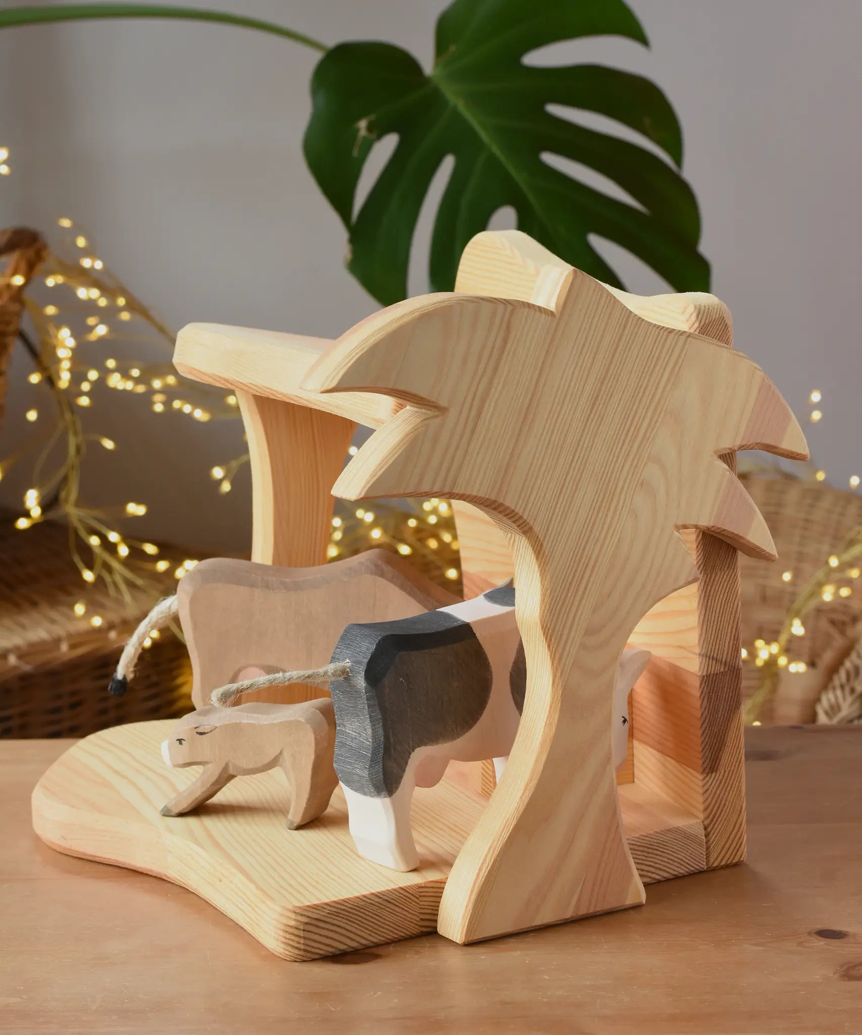 Ostheimer small wooden toy stable with cow figures placed inside. 