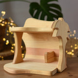 Ostheimer small wooden toy stable placed on a wooden surface.