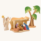 Ostheimer small wooden toy stable on a plain background. The stable has been filled and surrounded by Ostheimer nativity themed figures. 