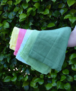 Ostheimer Spring decoration scarves play cloths draped over a child's arm.
